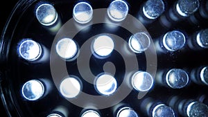 Macro view of lit LED lamps of a portable flashlight in perspective