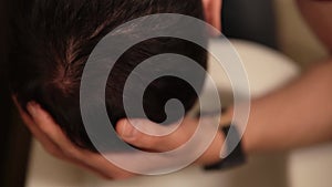 Macro view of a man leaning over toilet feeling nausea and touching head by his hand filmed