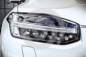 Macro view of modern car headlight SUV with noise graine effect. car xenon lamp headlight. detail view on car xenon lamp