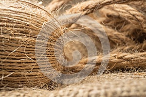 Macro view with natural jute twine roll isolated on natural linen fabric