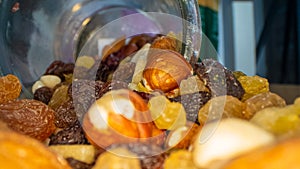 Macro view of the nuts, seeds and dried fruits in a glass jar
