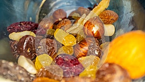 Macro view of the nuts, seeds and dried fruits in a glass jar