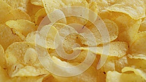 Macro view of potato chips spinning close up. Golden fried potatoes, Junk food