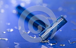 Macro view of safety razor blade on water drops background