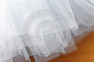 Macro view of sewing dresses. Close Up of fabric mesh for Tutu. Children`s dance skirt. Net wedding textile