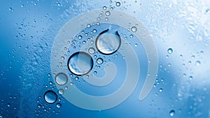 Macro view of water droplets on a blue surface with light reflections