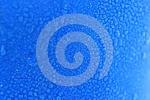 Macro water drops background on blue cup.