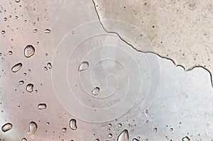 Macro of wet dirty old steel kitchen sink. Water droplets with dirt all around