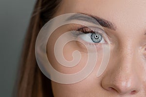 Macro of woman blue eye with false eyelashes. Vision correction