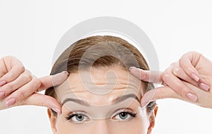 Macro Woman face with wrinkles on the forehead. Collagen and face injections concept. Skin care. Cropped image. Copy space.