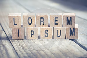 Macro Of The Words Lorem Ipsum Formed By Wooden Blocks On A Wooden Floor