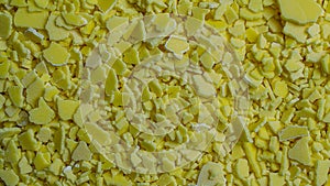 macro yellow sodium sulfide flakes on tapete photo