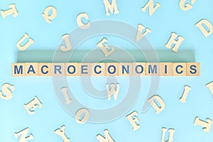 Macroeconomics concept in finance and economics. Word typography on wooden blocks flat lay.