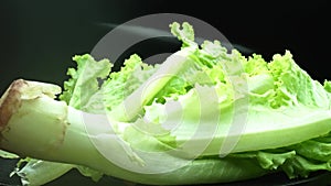 Macrography, lettuce leaves stand out against a black background. Comestible.