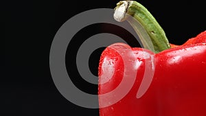 Macrography of a red bell pepper with black background. Close up. Comestible. photo