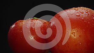 Macrography, tomatoes nestled within basket with black background. Comestible.