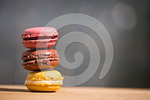 Macrons lie consecutively on wooden background