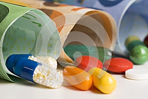 Macrophotography with colourful pharmaceutical drugs on rolled up euro banknotes