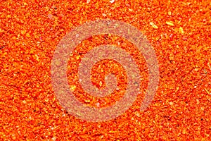 Macrophotography of ground red paprika on a flat surface. Flavorful seasonings