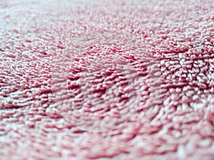 Macroshot texture of red terry cloth with copy space. Selective focus surface of fuzzy towel. Things for home use