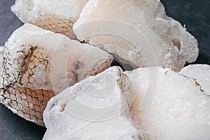 Macrourus fish frozen, fresh, sliced and cut in portions. Gray background