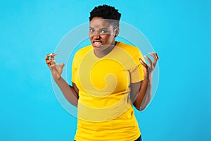 Mad African Woman Freaking Out Looking Angrily Posing, Blue Background