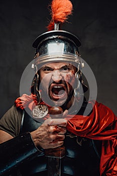 Mad armoured military roman screaming in dark background