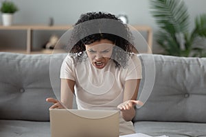 Mad biracial woman scream having laptop problems