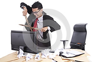 Mad businessman cutting computer