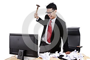 Mad businessman hitting his computer