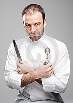 Mad Chef Holding Kitchen Tools