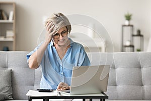 Mad concerned older retired woman in glasses getting financial problems