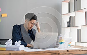 Mad crazy man employee sitting in office workplace with sticky notes all around, shouting furious angry, pissed off