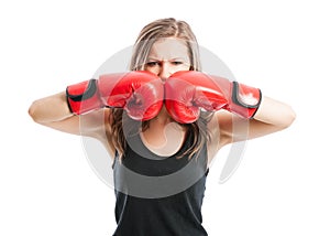 Mad female boxer touching red boxing gloves together