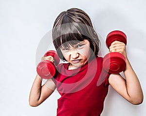 Mad frowning child expressing rage and violence with bully dumbbells