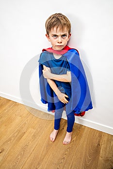 Mad little superhero child conflicted by parents for domestic violence photo