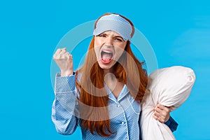 Mad, outraged and furious redhead caucasian girl shouting, cursing roommate being too loud at night, cant sleep, shaking