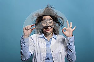 Mad wacky scientist with glass microscope slide looking satisfied after laboratory experiment explosion.