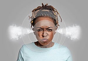 Mad young black lady with steam coming out of ears