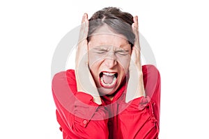 Mad young woman screaming, covering her ears to refuse to listen