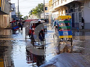 : Difficult work of a rickshaw in puddles after rain. November 21, 2022 Madagascar