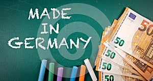 MADE IN GERMANY. Euro money on a green chalkboard