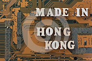 MADE IN HONG KONG text on gold printed circuit board. Warehouse logistics concept. Digital electronic technology