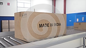 Made in INDIA import and export concept. Cardboard boxes with product from INDIA on the roller conveyor