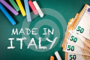 Made in Italy. Euro money and pieces of chalk on a green board