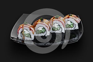 made Japanese sushi rolls served on a black stone slab