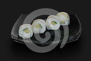 Made Japanese sushi rolls served on a black stone slab