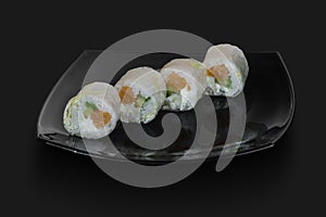 made Japanese sushi rolls served on a black stone slab