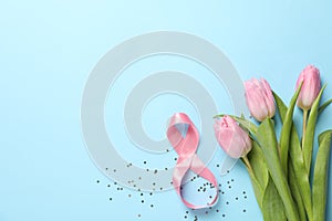 8 made of ribbon and pink tulips on blue background