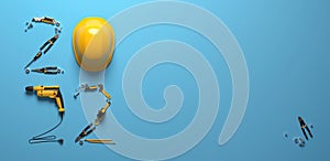 `2022` made from a set of construction tools and a protective helmet on a blue background.